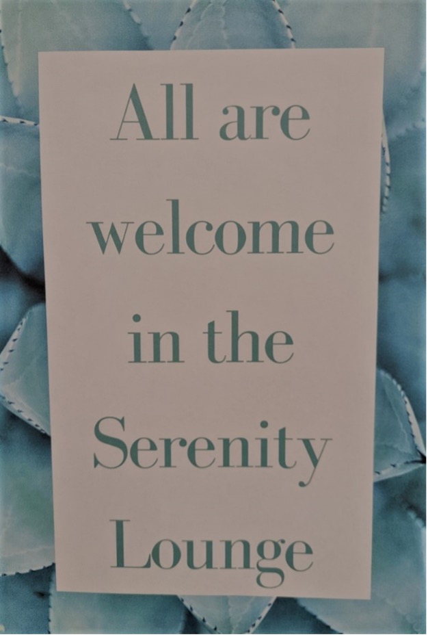 Aloe plant background, center block reading “All are welcome in the Serenity Lounge”