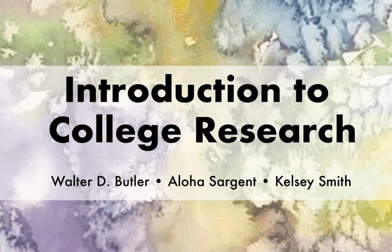 The textbook cover with title, authors, and colorful abstract watercolor design